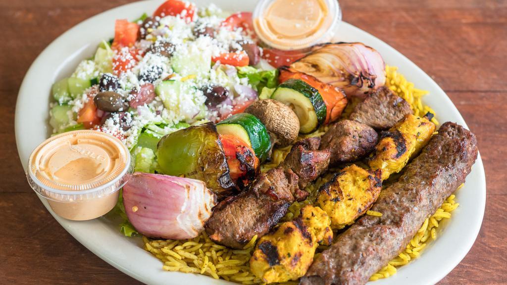 The Blazin' Platter · Four kebab skewers of fire grilled chicken, kafta and lamb and charbroiled vegetables. Served on a bed of rice and Greek salad. Feta cheese, our signature Blazin' Sauce, and tzatziki sauce.

Please allow additional time for your fresh kebabs to be fire grilled to perfection.