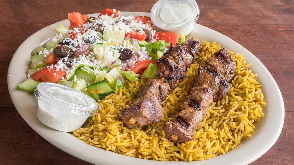 Lamb Kebab Platter · 2 skewers of seasoned charbroiled lamb kebab served on a bed of rice along with Greek salad and dressing.

Please allow additional time for your fresh kebabs to be fire grilled to perfection.