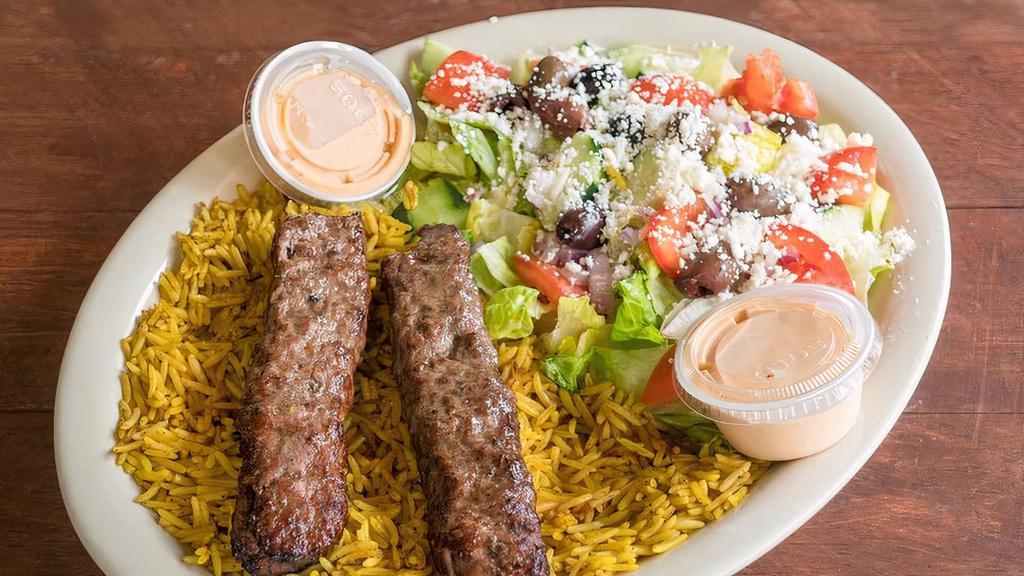 Kafta Kebab Platter · 2 fire grilled ground lamb/beef mixed with spices, finely chopped onions and parsley charbroiled to perfection served on a bed of rice along with Greek salad and dressing.

Please allow additional time for your fresh kebabs to be fire grilled to perfection.