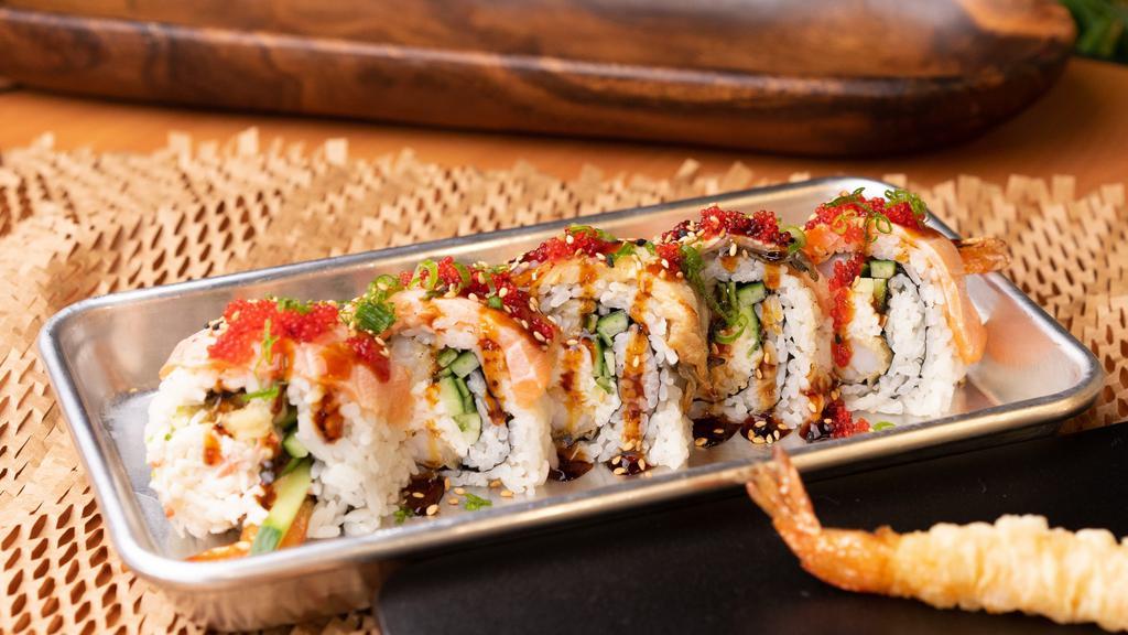 Ultimate · Shrimp tempura roll. Topped w/ seared salmon, unagi, tobiko, green onion and sesame seeds. Unagi sauce.