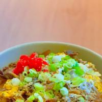 Beef Sukiyaki Donburi · Thin-sliced beef, onions, egg, pickled ginger, rice.