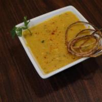 Dal Tadka. · Moong Dal boiled and cooked with onion, tomatoes and tempered with traditional Indian spices...
