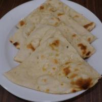 Plain Naan. · Flat bread cooked in traditional clay oven