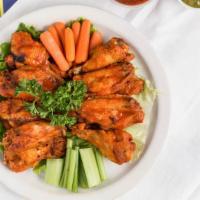 Wings · Twelve pieces chicken wings deep fried to a crisp golden and tossed in your choice of: Buffa...