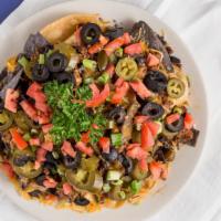 Nachos · Spicy beef and black beans on a bed of homemade corn tortilla chips topped with cheese, toma...