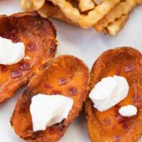 Potato Skins (6 Pc)* · Served with cheese, bacon bits, sour cream.