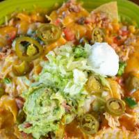 Nachos · Crispy corn tortilla chips topped with pickled jalapenos, refried beans, sour cream, guacamo...