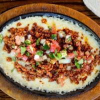 Queso Fundido · Melted asadero cheese topped with chorizo and pico de gallo. Served with tortillas.