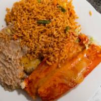Tamale Plate · Two homemade red or green pork tamales, smothered with green chili. Served with rice, beans,...
