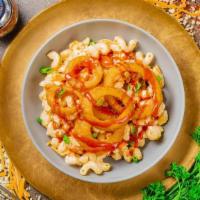 Cowboy Mac · Cheddar, onion rings, BBQ sauce, and green onion on a bed of mac and cheese pasta.