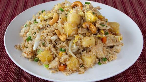 Pineapple Fried Rice · Egg, onion, cashew nut, pea, carrot, and pineapple.