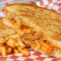 Pork And Mac · BBQ SHREDDED PORK, MAC ,SWISS, PROVOLONE AND CHEDDAR CHEESE ON WHITE PARESAN CRUSTED BREAD