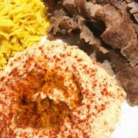 Lamb Gyro( Plate)لام مع الرز · Lame Over rice salad Hummus Tazaki and pita bread and hot sauce garlic sauce
