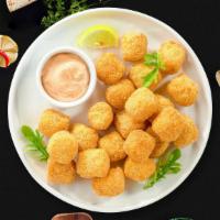 Tots Of You · (Vegan) Shredded Idaho potatoes formed into tots, battered, and fried until golden brown.