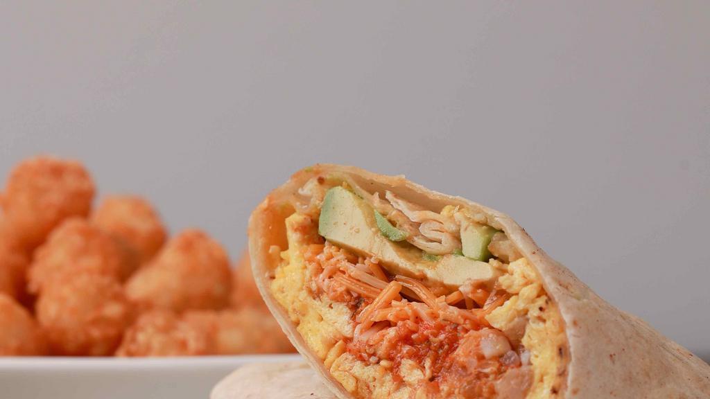 Lucky Charmer · Eggs, tater tots, ham, avocado, hot peppers, salsa roja and shredded cheddar jack cheese rolled in a flour tortilla wrap. Served with hot sauce.