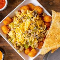 Sausage Scrambler · Eggs scrambled with sausage, mushrooms, onions and bell peppers on a bed of tater tots.  Ser...