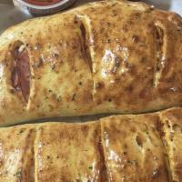 Meat Feast Calzone · Red sauce, Canadian bacon, pepperoni, Sweet Italian sausage, meatballs, salami, ricotta and ...
