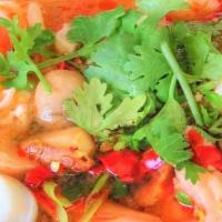 Tom-Yum Seafood Noodle Soup · Sour and spicy noodle soup with shrimp, squid & fishball. Served with scallions, onions and ...