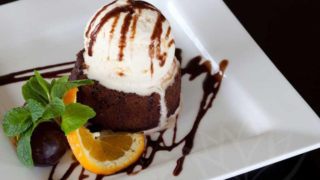 Molten Lava Chocolate Cake With Vanilla Bean Ice Cream · Warm, rich chocolate cake filled with molten chocolate; perfectly paired with a topping of vanilla-bean ice cream.