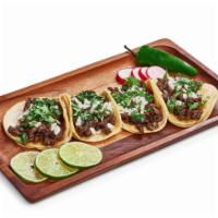 Tacos · corn tortillas stuffed with choice of meat, onions and cilantro