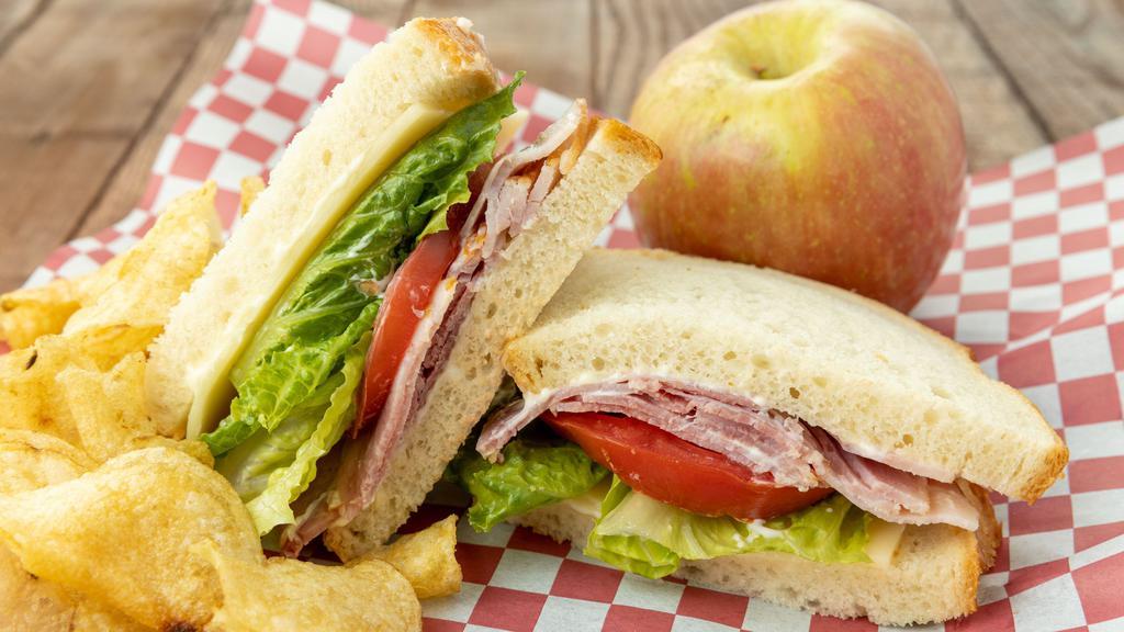The Classic · Choice of turkey, ham or roast beef, Swiss or cheddar, tomato, lettuce and mayonnaise on sliced white or multi-grain wheat.