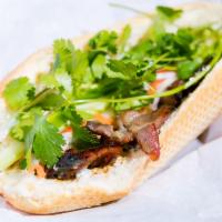 Grilled Pork Sandwich · French baguette, mayonnaise, carrot, daikon slaw, cilantro, jalapeño and house sauce.