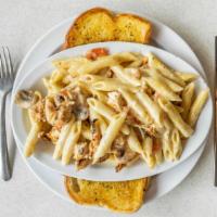 Blackened Chicken Alfredo · Grilled Chicken seared in Cajun spices, served with tomatoes mushrooms and penne pasta in a ...