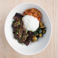 Galbi · Korean beef short ribs. Marinated Korean beef short ribs, scallion, roasted sesame, sautéed ...