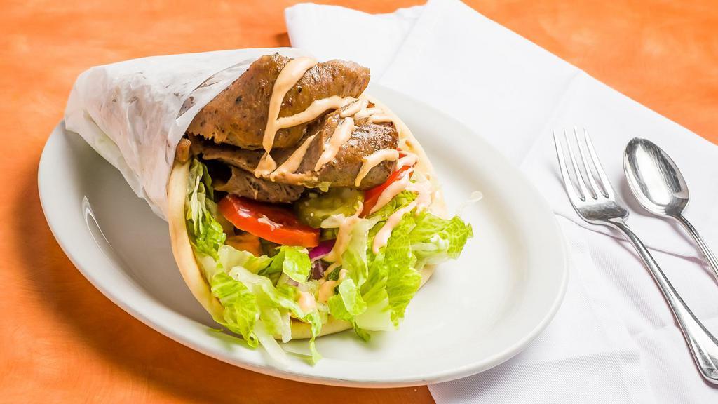 Lamb Gyro · Slow roasted lamb and beef slices, seasoned with our special mediterranean spices topped with tzatziki sauce and wrapped in a soft, warm pita.