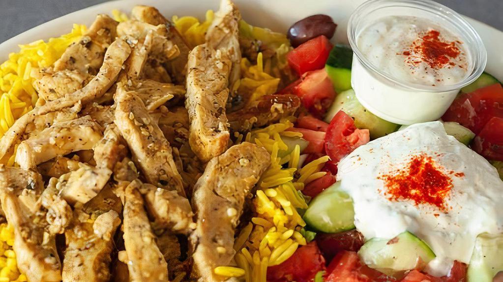 Chicken Shawarma Plate · Grilled chicken shawarma drizzled with our home made tzatziki sauce, served with a bed of basmati rice and Greek salad.