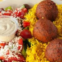 Falafel Platter · Falafel served on a bed of basmati rice alongside Greek salad. Comes with a choice of hummus...