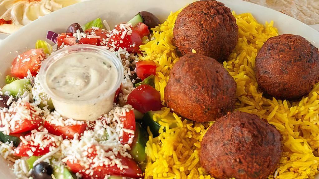 Falafel Platter · Falafel served on a bed of basmati rice alongside Greek salad. Comes with a choice of hummus or baba ghanouj as your side with a complementary pita bread.