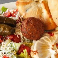 Vegetarian Plate · A combination of hummus, falafel, dolma, Greek salad and pita bread with a choice of spinach...