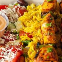 Chicken Kebab Plate · Two chicken kebab skewers served with a bed of basmati rice and Greek salad.