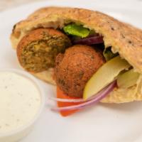 Falafel · Deep-fried patty shaped protein made from ground chickpeas and beans.