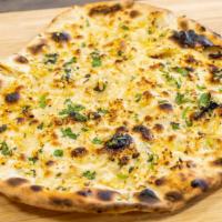 Garlic Naan · Naan bread with a spread of garlic and cilantro cooked in tandoor oven.