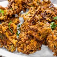 Vegetable Pakora (12 Piece) · Fresh vegetables mixed in batter with herbs and deep fried.