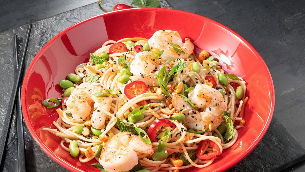 Noodle Salad With Shrimp · Chilled ramen noodles, shredded carrots, green onions, Fresno peppers, edamame, basil, and mint tossed in spicy Sesame Ginger sauce and served with seared shrimp. Garnished with sesame seeds, green onions, and spicy chopped peanuts.