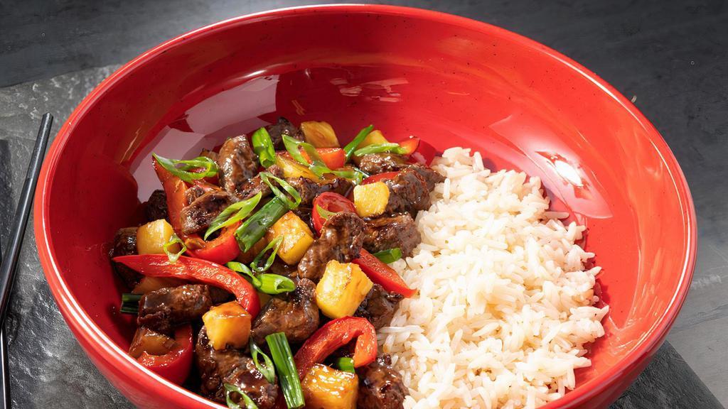 Kyoto Teriyaki Steak · Sirloin steak tips, fresh cut pineapple, red bell pepper, and green onions tossed in Kyoto teriyaki sauce and served on a bed of white rice. Garnished with green onions.