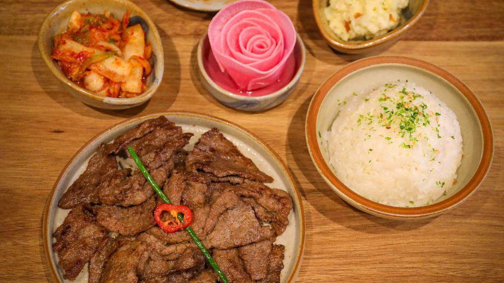 Beef Bulgogi Bento · Thin sliced rib eye, marinated with fruit and sweet soy sauce, onion, scallion. Served with rice, 4 side dishes and house salad.