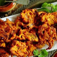 Onion Pakora · Onion, flour , cilantro mixed together and fried together. It is a great crispy snack with a...