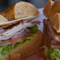 Club · Turkey, ham, bacon, choice of cheese, lettuce, tomato, and onion on a choice of toasted bagel.