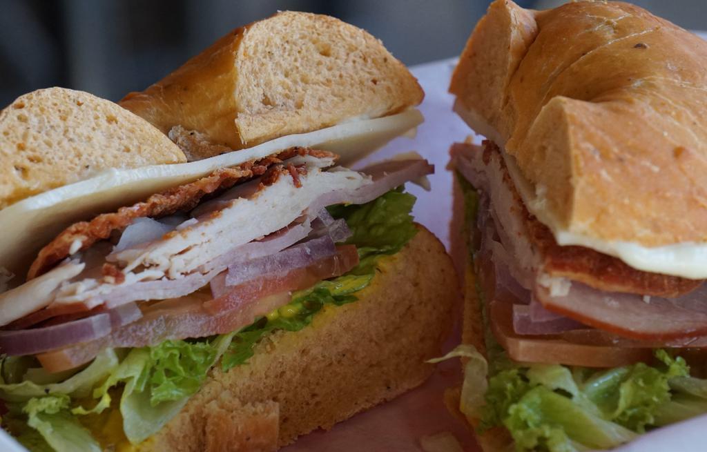 Club · Turkey, ham, bacon, choice of cheese, lettuce, tomato, and onion on a choice of toasted bagel.