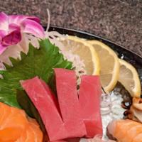 Sushi & Sashimi Combination · Sashimi: tuna (3), salmon (2), yellowtail (2). Sushi: shrimp, eel, albacore. Served with sou...