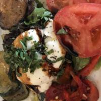 Burrata · Homemade creamy mozzarella with grilled vegetables and tomatoes, mixed greens and EVOO