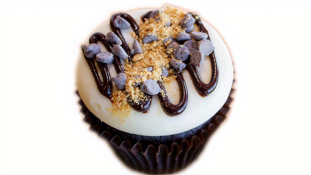 Chocolate Cheesecake · Chocolate cake, with a graham cracker crust bottom. Topped with cream cheese buttercream, chocolate sauce, chocolate chips, and more graham cracker crumbs.