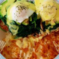 Eggs Benedict · Two poached eggs, tomatoes, avocado, spinach, and hollandaise sauce over English muffins. Wi...
