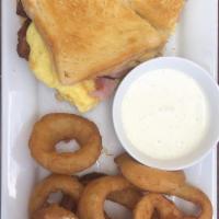 Breakfast Sandwich · Sourdough bread, swiss cheese, American cheese, ham, two omelet style eggs served hash brown...