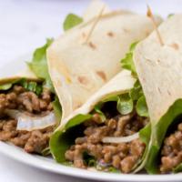 Shredded Beef Street Taco · Shredded beef, lettuce, and creamy cheese sitting on a fresh made tortilla.