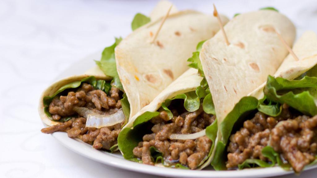 Shredded Beef Street Taco · Shredded beef, lettuce, and creamy cheese sitting on a fresh made tortilla.